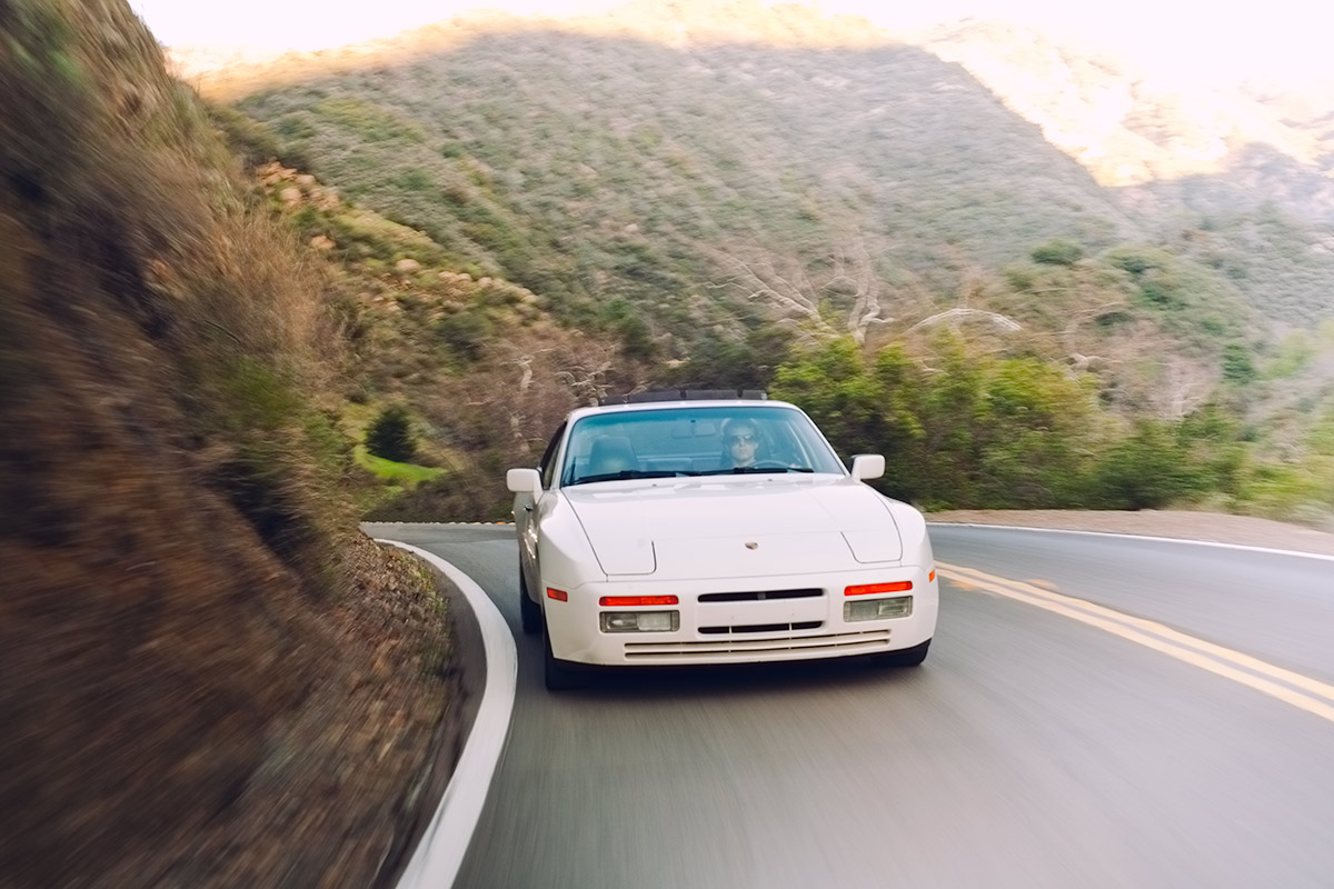 White Porsche 944 Turbo (951) driving through the hills of Southern California