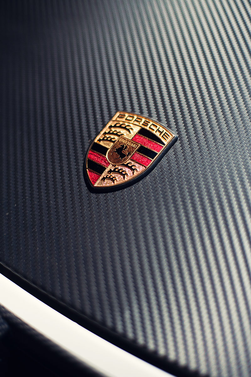 Porsche emblem crest on Carbon Fiber hood