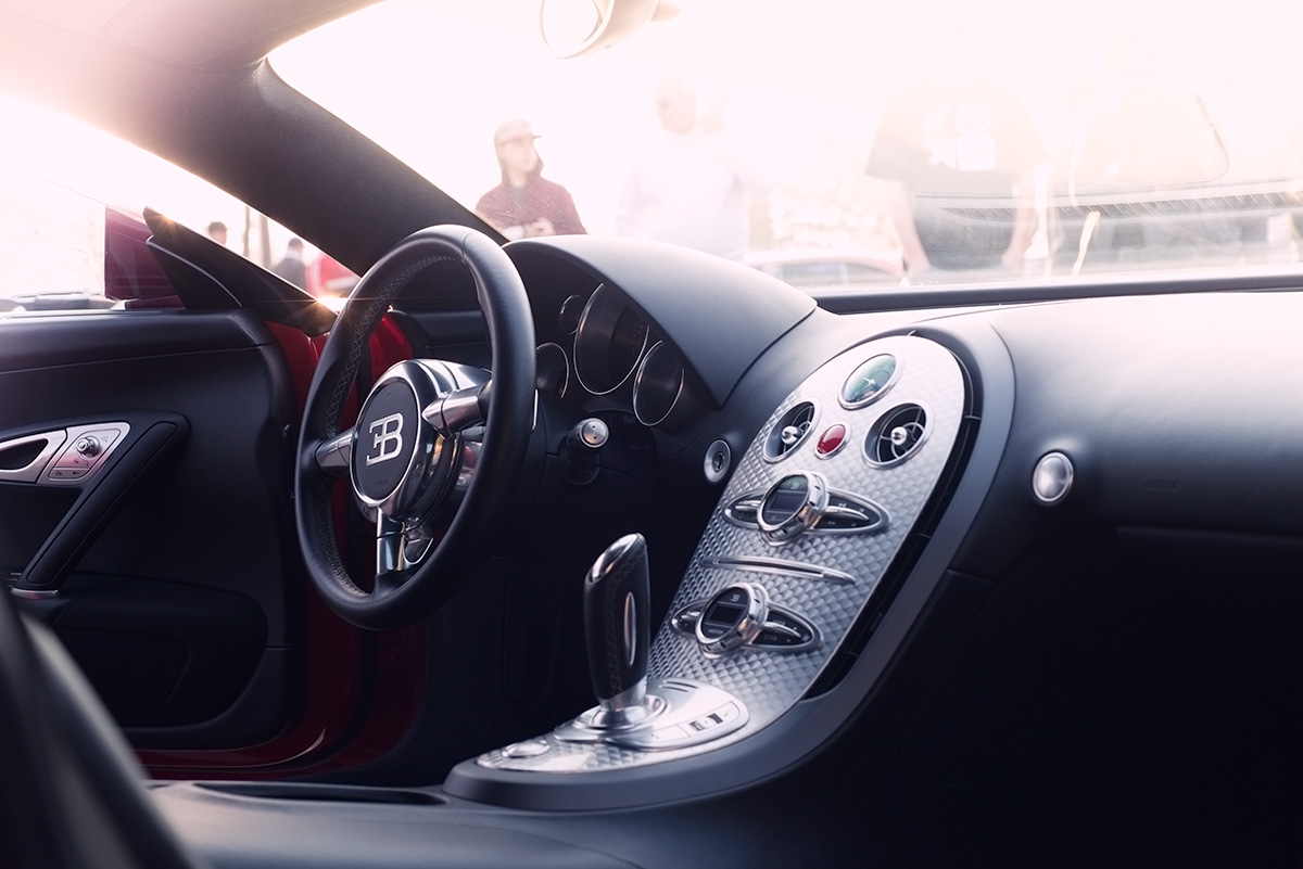 Red Bugatti Veyron with black interior and aluminum dash